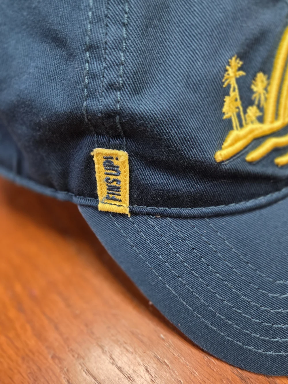 Embroidered Blue Baseball Cap with Yellow Shark Fin Motif